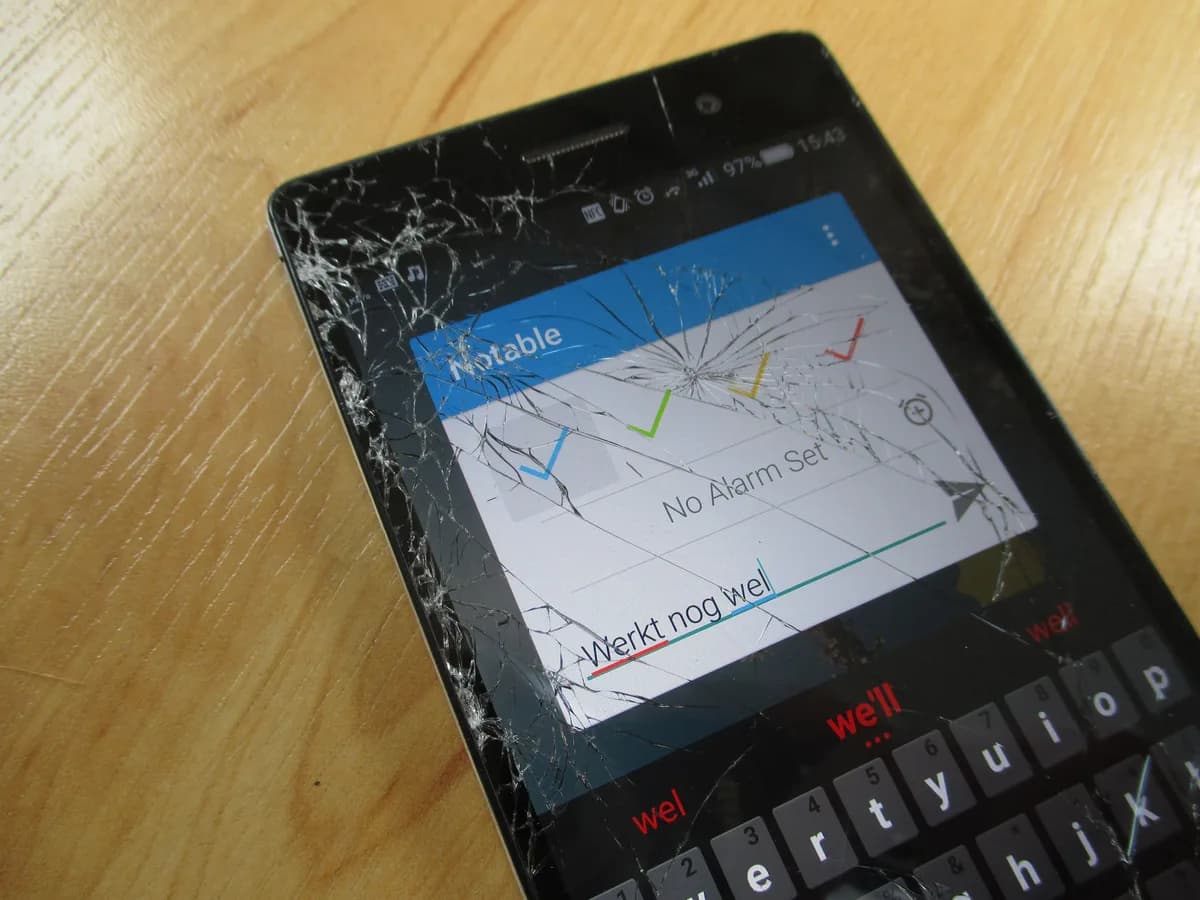 Phone with cracked glass whose display still shows a picture